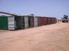 A row of sea containers - most of the equipment we use is shipped to from the US by sea in these cargo containers.