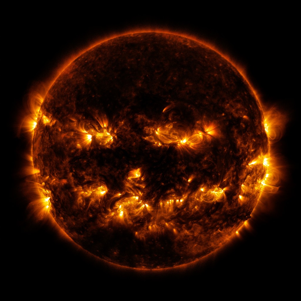 On October 8, 2014, active regions on the sun gave it the appearance of a jack-o'-lantern. This image is a blend of 171 and 193 ångström light as captured by the Solar Dynamics Observatory.