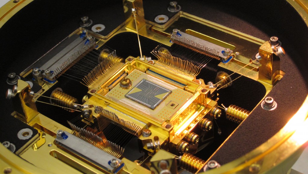 The heart of the ASTRO-H Soft X-ray Spectrometer is the microcalorimeter array at center. The five-millimeter square forms a 36-pixel array. Each pixel is 0.824 millimeter on a side, or about the width of the ball in a ballpoint pen. The detector's field of view is approximately three arcminutes, or one-tenth the apparent diameter of the full moon. Credit: NASA's Goddard Space Flight Center