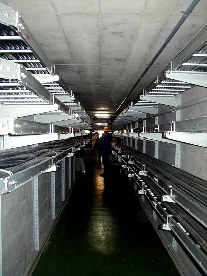 Dark and gloomy tunnel loaded with wire trays (58K JPEG)
