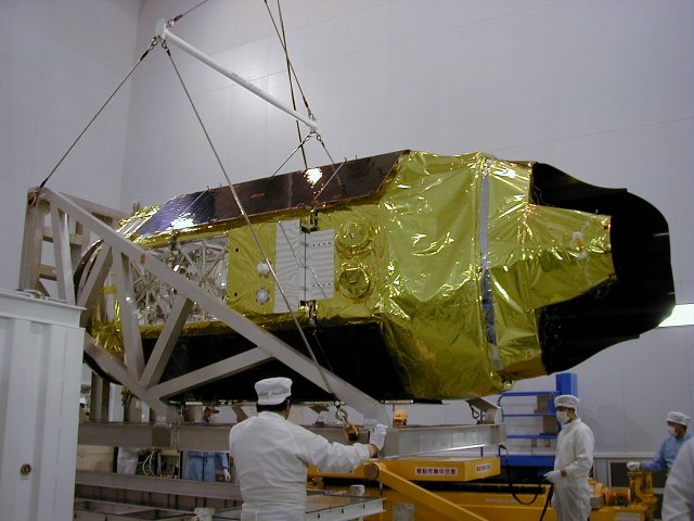 ASTRO-E held horizontally in an aluminum frame (62K JPEG)