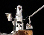 During the first spacewalk of SM4, astronauts John Grunsfeld and Andrew Feustel install Wide Field Camera 3