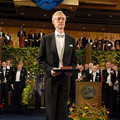 Dr. John C. Mather at the Nobel Award ceremony, standing with his award.