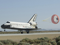 A drag chute slows the speed of STS-125 shuttle Atlantis as it touches down on Runway 22 at Edwards Air Force Base in California on May 24 at 11:39 a.m.