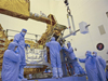 Goddard engineers and technicians install the replacement SIC&DH onto the Multi-use Logistics Equipment (MULE) Shuttle carrier in the Payload Hazardous Systems Facility (PHSF) at the Kennedy Space Center