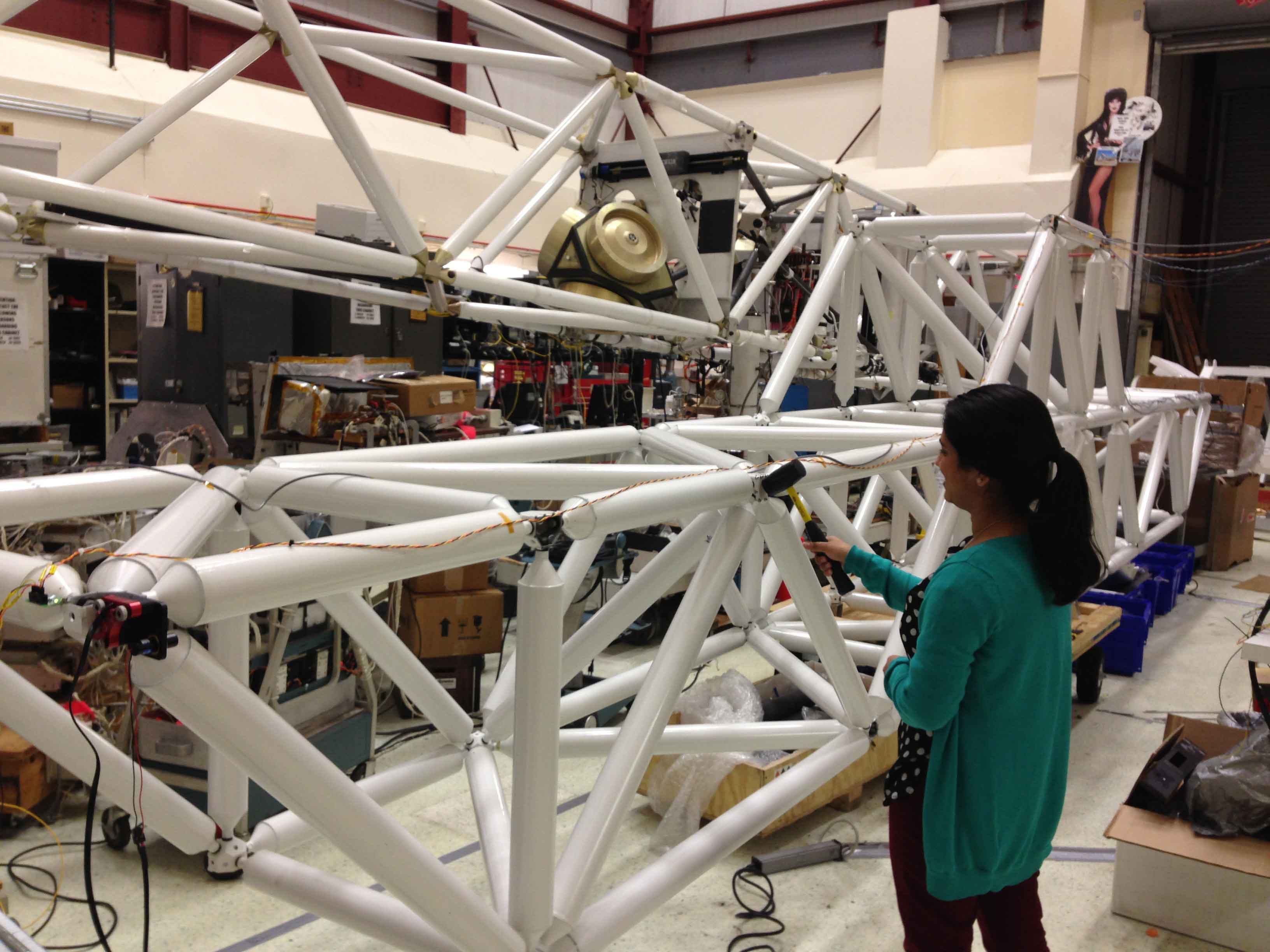 Sajeela studying the vibration modes in the structure by whacking it with a hammer and recording accelerometer responses