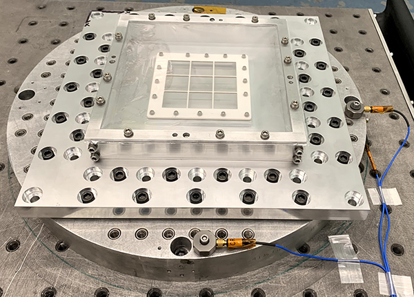 An image of a 282.6K-pixel NGMSA mechanical structure hybrid mounted on a vibration table for random vibe and acoustic vibe tests.